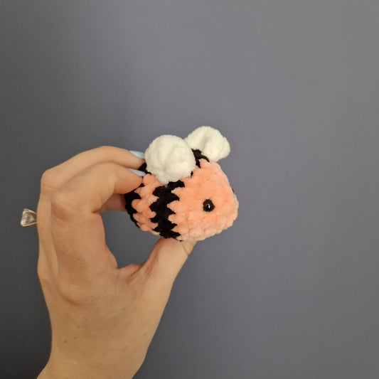 Salmon pink coloured chunky crochet bee keyring