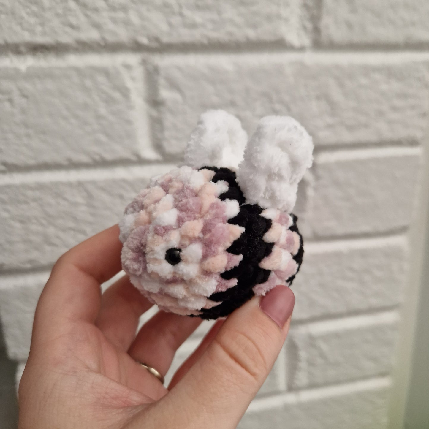 Dusty pink, white, sand and black coloured chunky crochet bee keyring