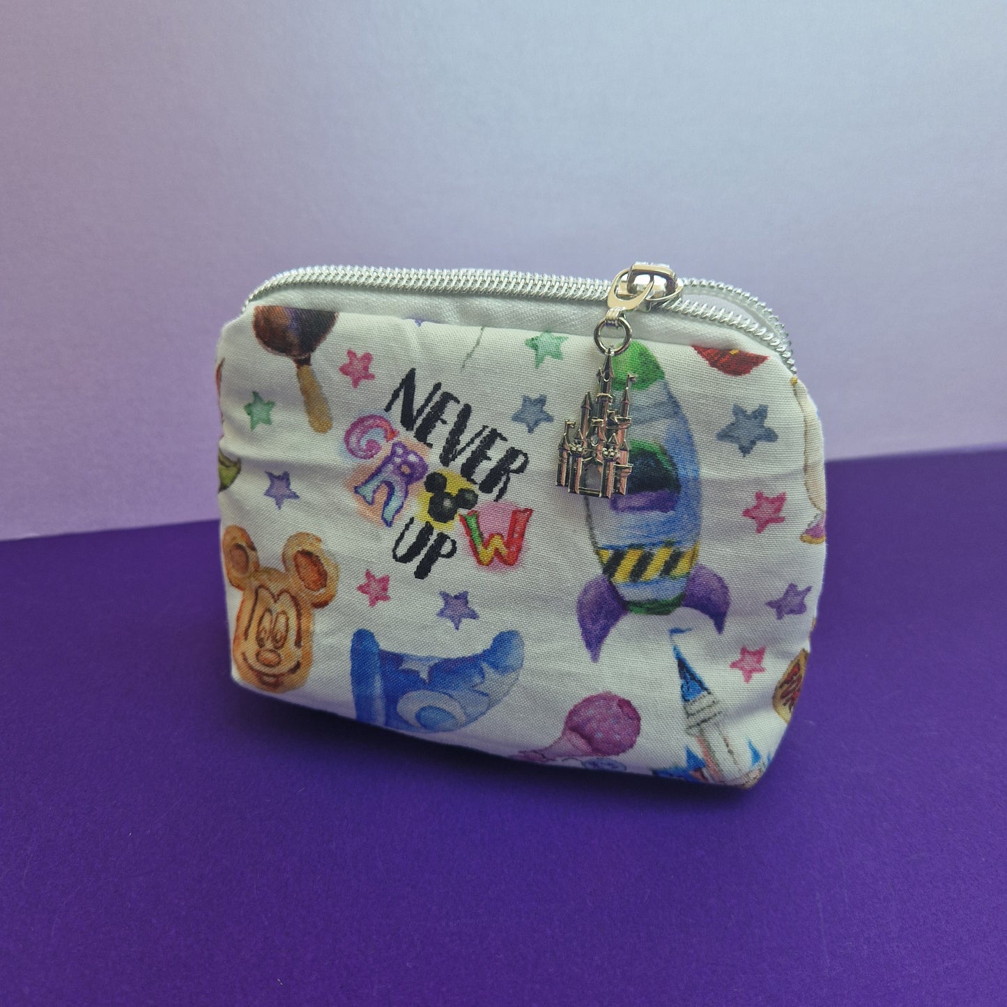 Never Grow Up icon lined mini triangle shaped pouch cosmetic bag with castle zipper pull