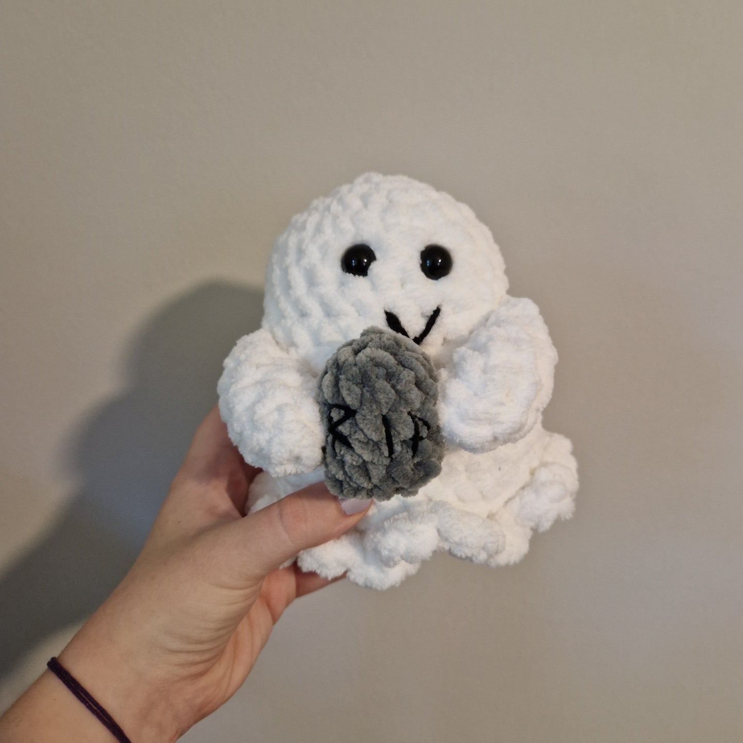 Spooky ghost holding an accessory crochet plushie