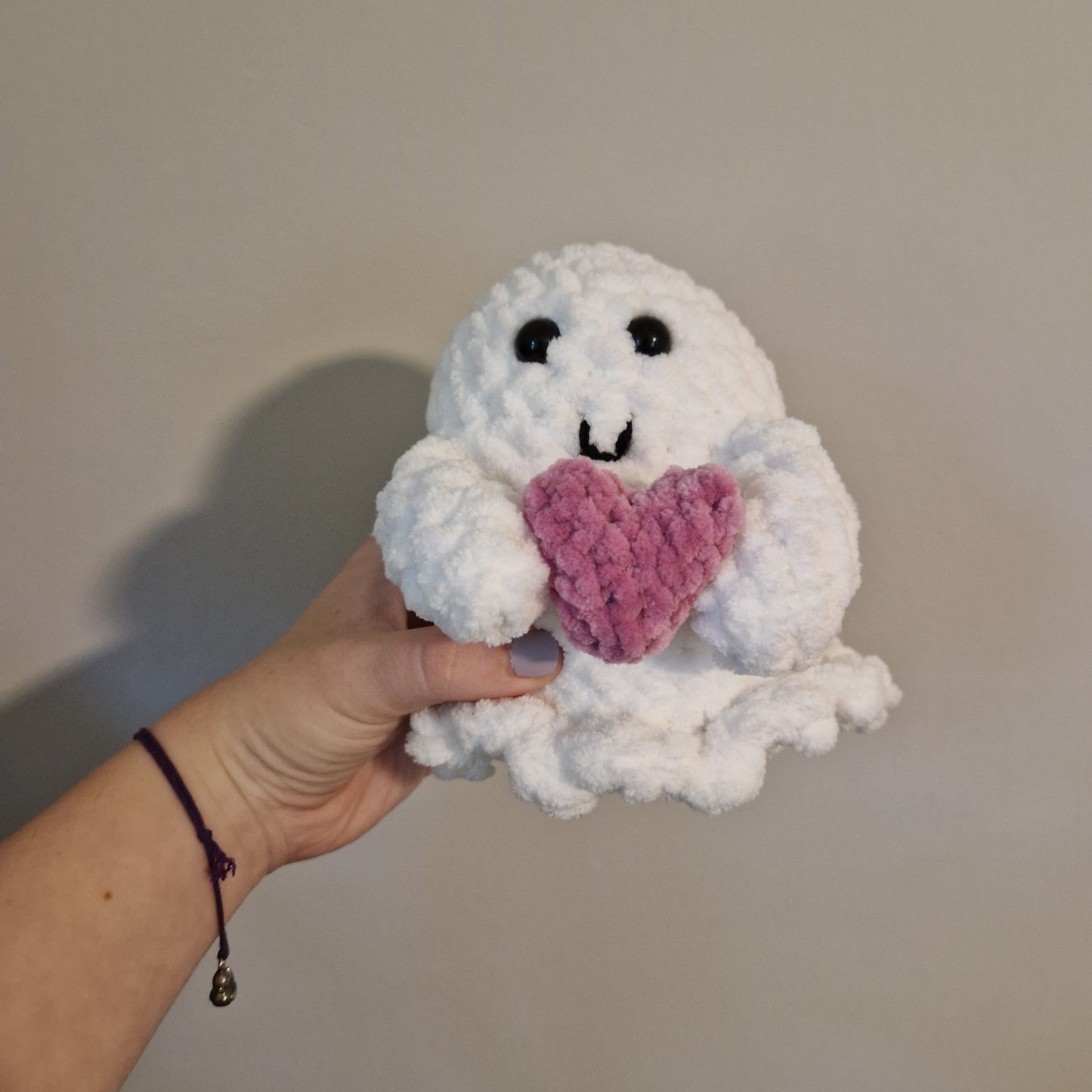 Spooky ghost holding an accessory crochet plushie