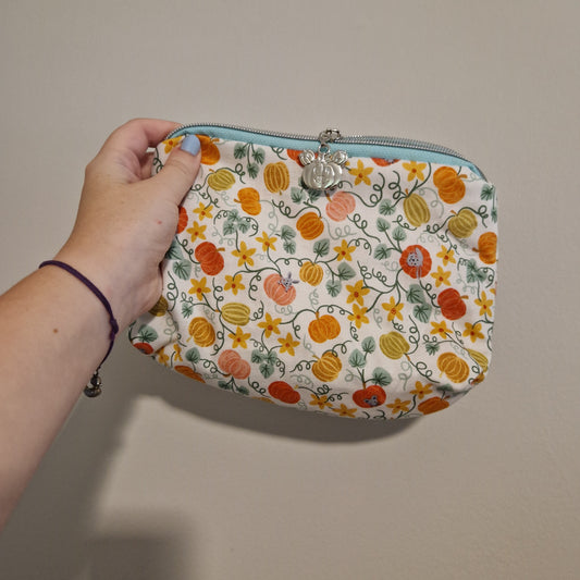 Pumpkin mouse lined triangle cosmetic bag with water tower zipper pull