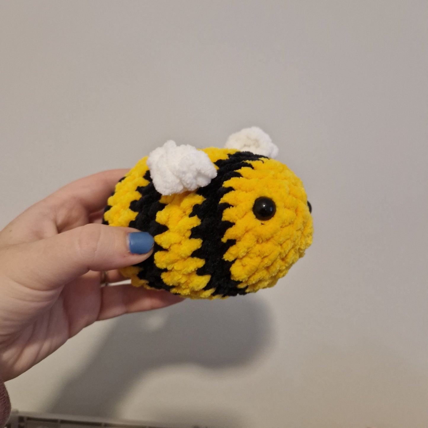 Bright yellow chenille crochet bumble bee