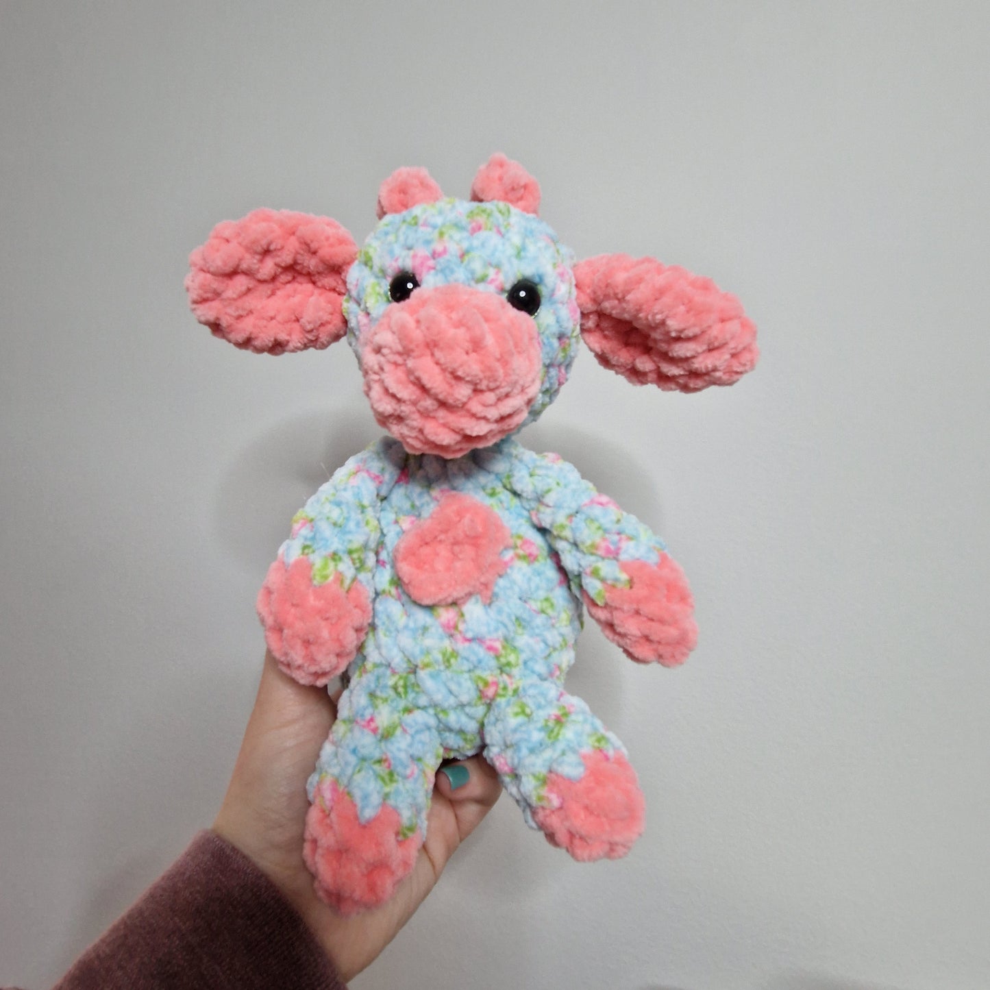 Pink and blue floral sitting cow crochet plushie