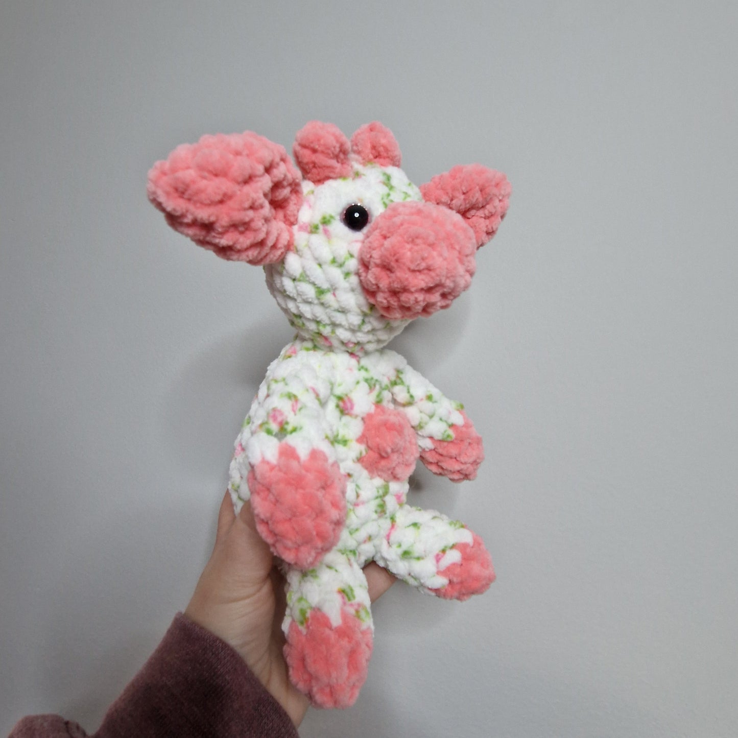 Pink and white floral sitting cow crochet plushie