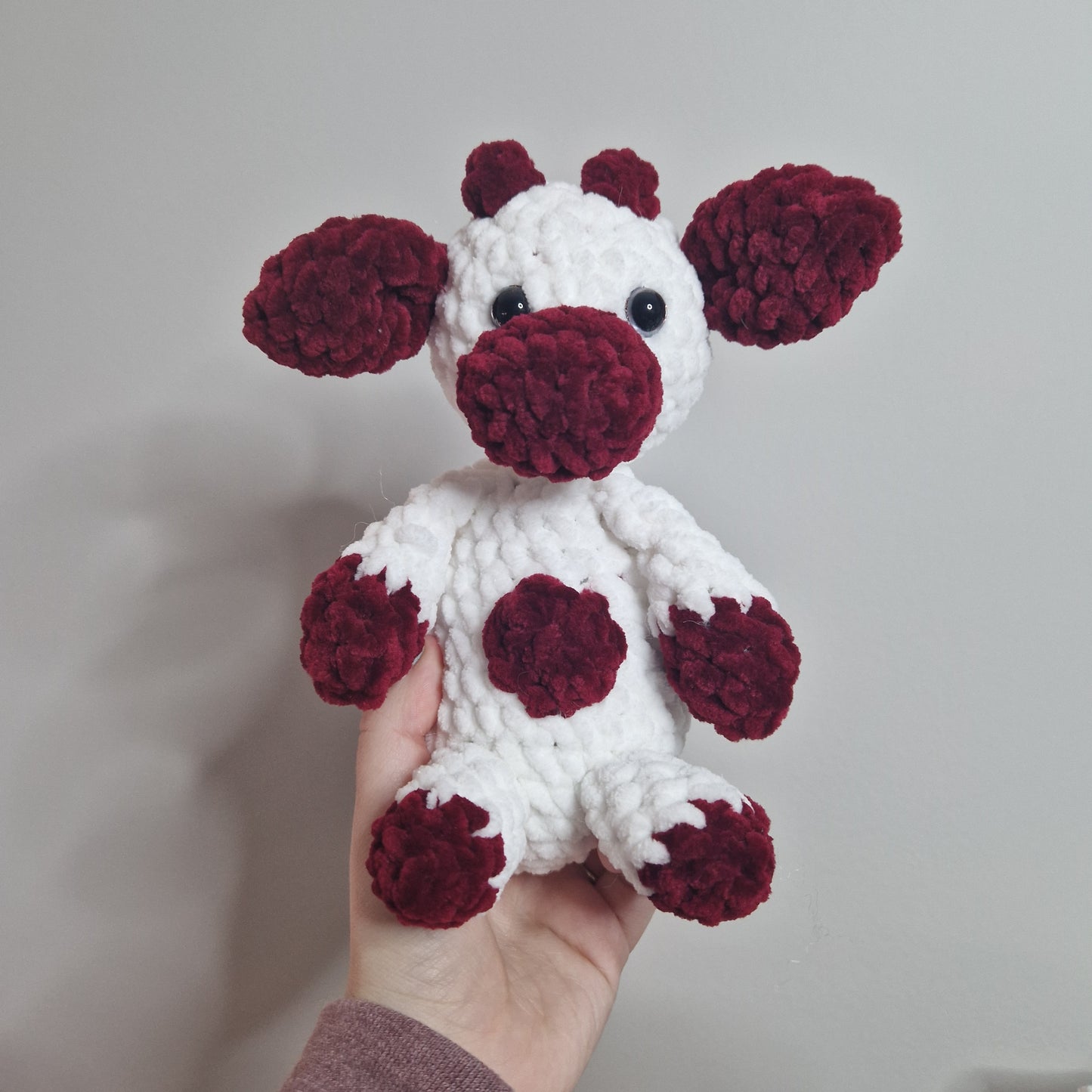 Red and white sitting cow crochet plushie