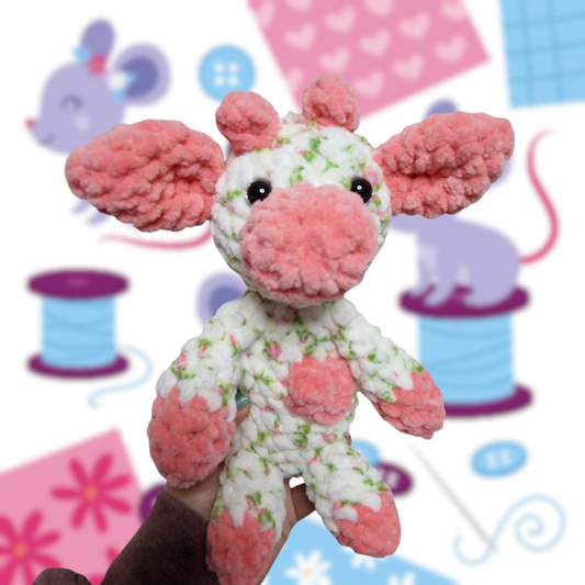 Pink and white floral sitting cow crochet plushie