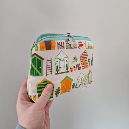 Gardening themed lined triangle cosmetic bag with matching zipper pull