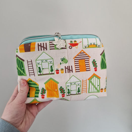 Gardening themed lined triangle cosmetic bag with matching zipper pull