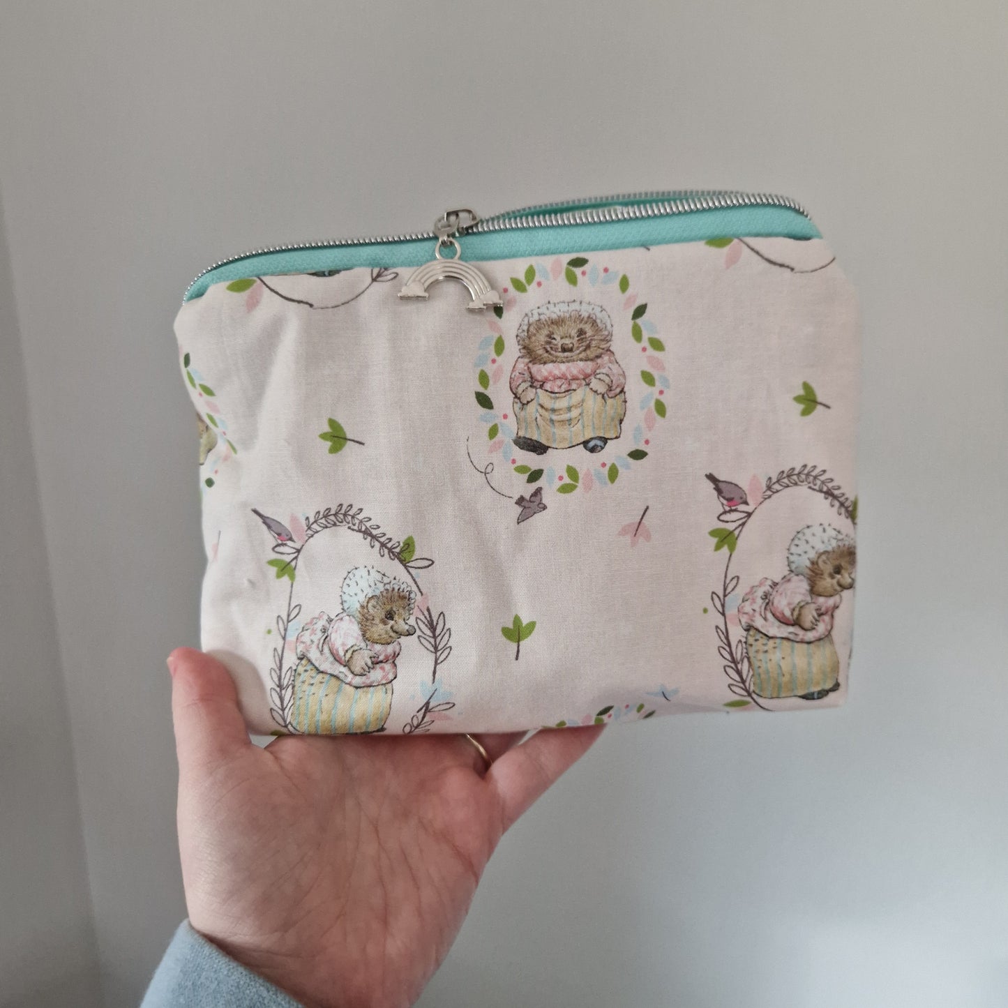 Hedgehog themed lined triangle cosmetic bag with matching zipper pull