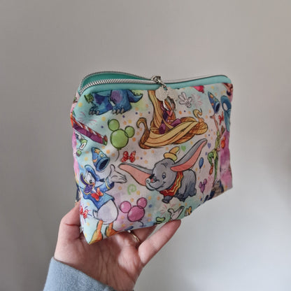 Character themed lined triangle cosmetic bag with matching zipper pull