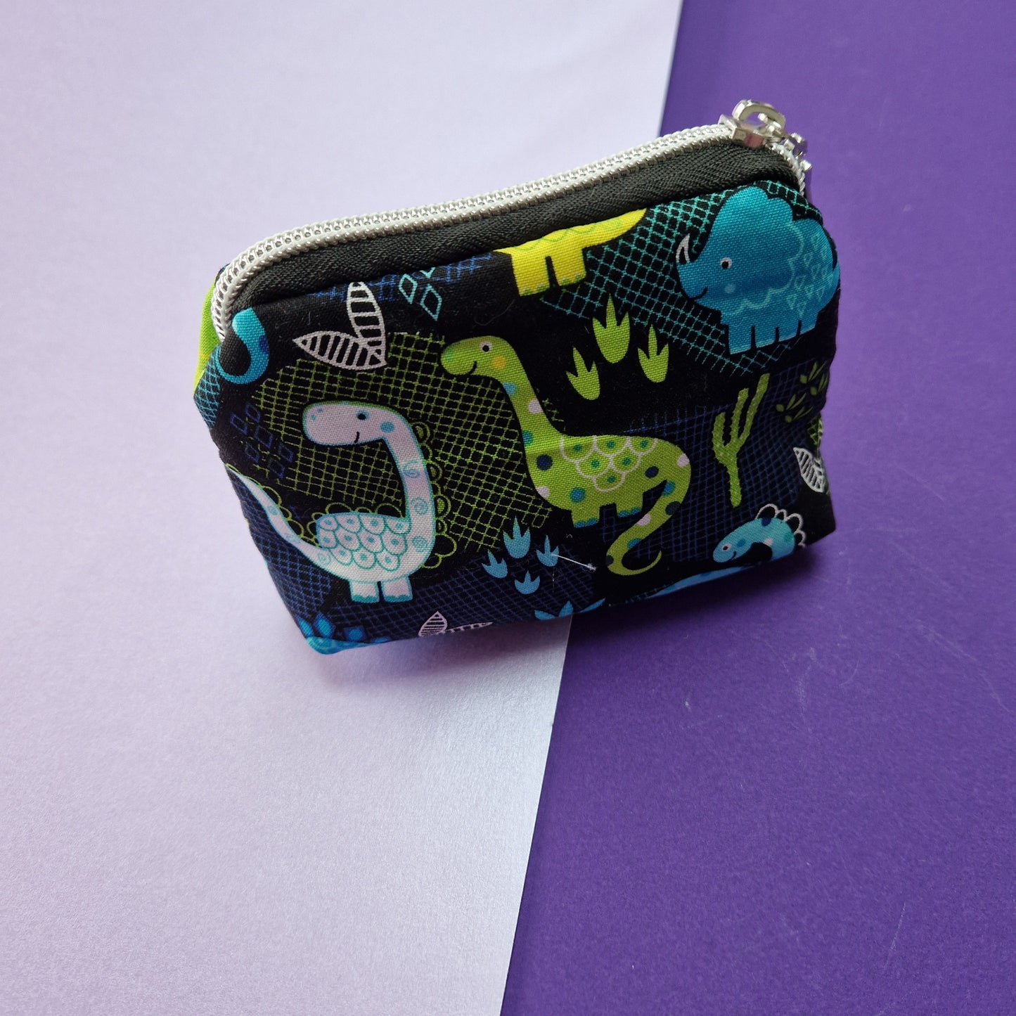 Dinosaur lined mini triangle shaped pouch cosmetic bag with zipper